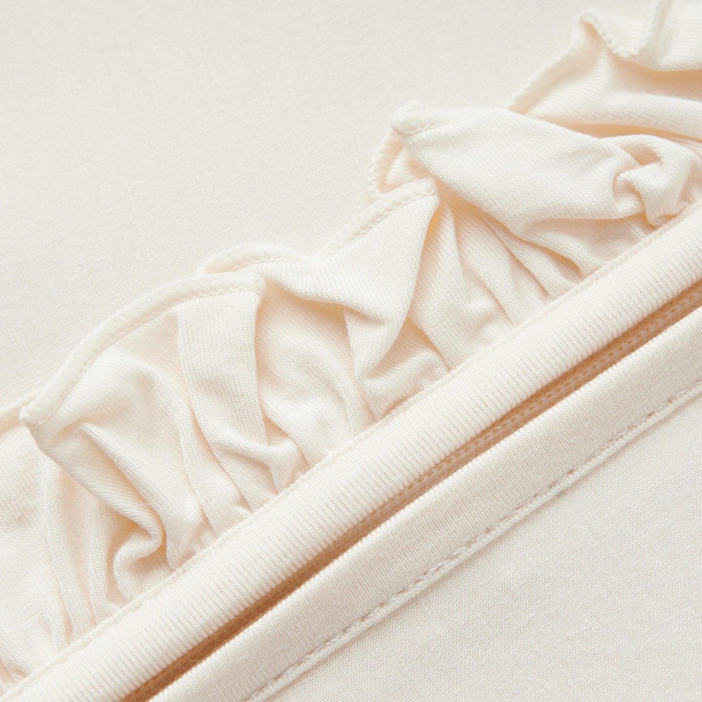 Salt Luxe Solid Ruffle Footed Romper