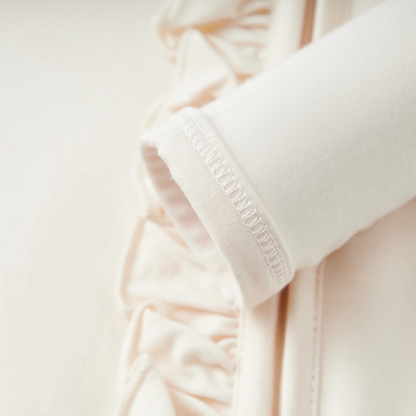 Salt Luxe Solid Ruffle Footed Romper