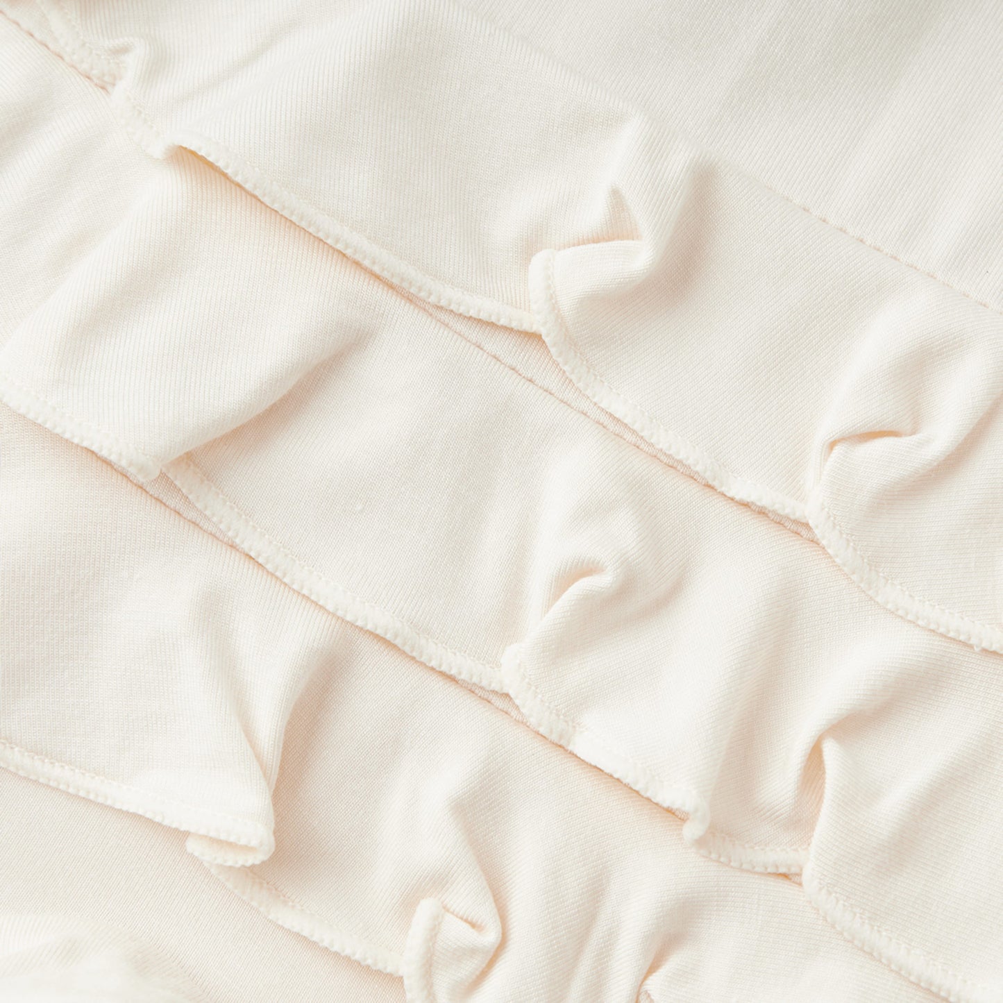 Salt Luxe Solid Ruffle Footed Romper
